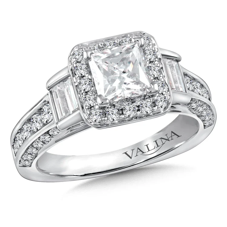 Diamond halo engagement ring mounting with baguette and round side stones set in 14k white gold.