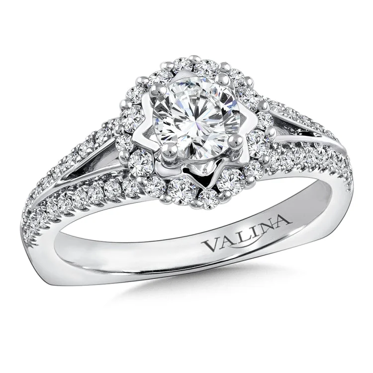 Diamond halo engagement ring mounting with side stones set in 14k white gold.